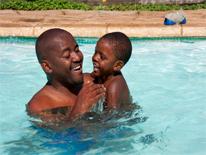 Father and son in a pool